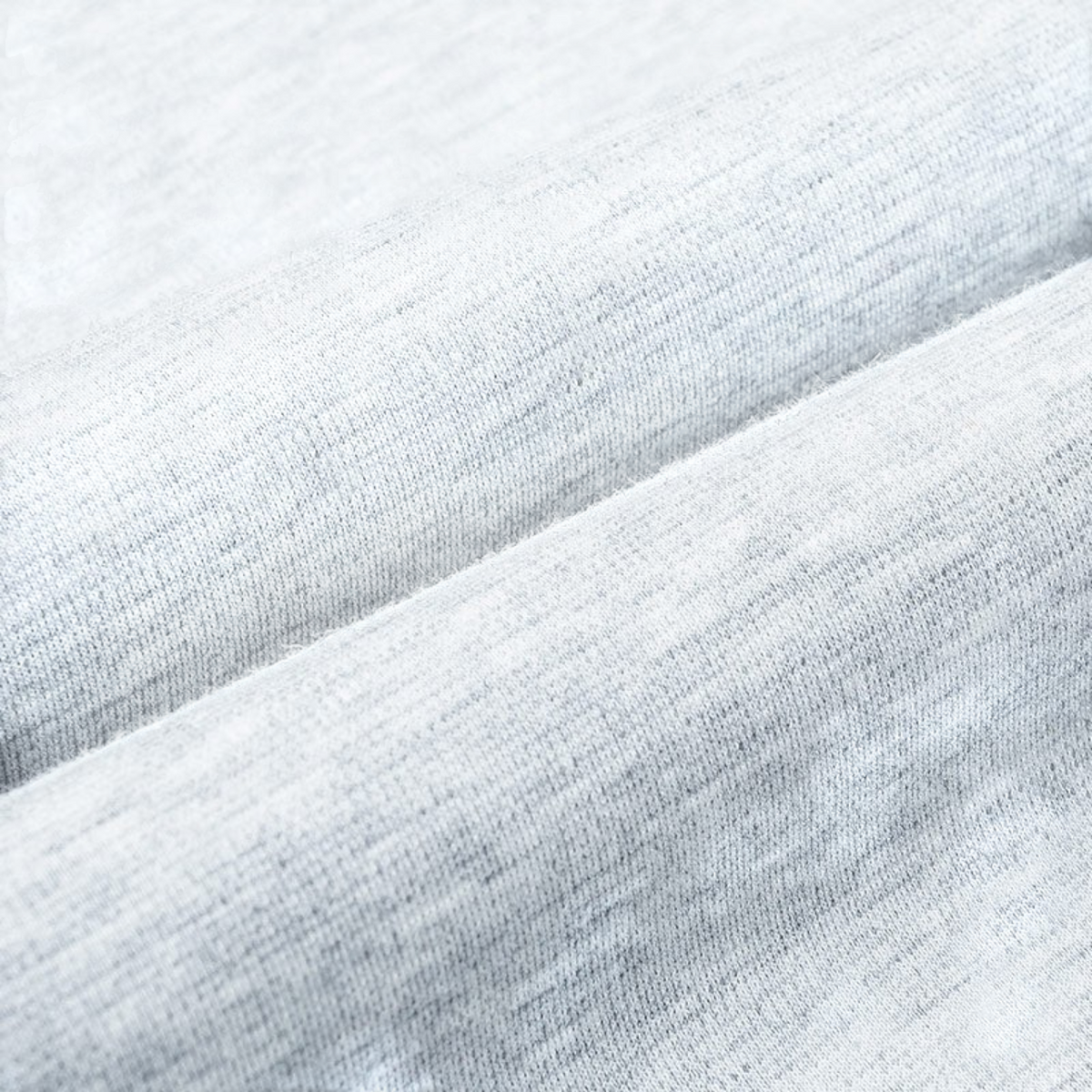 Close-up of heather grey Sorona knit fabric from FRG ANTA track pants showing soft, breathable cotton-polyester blend