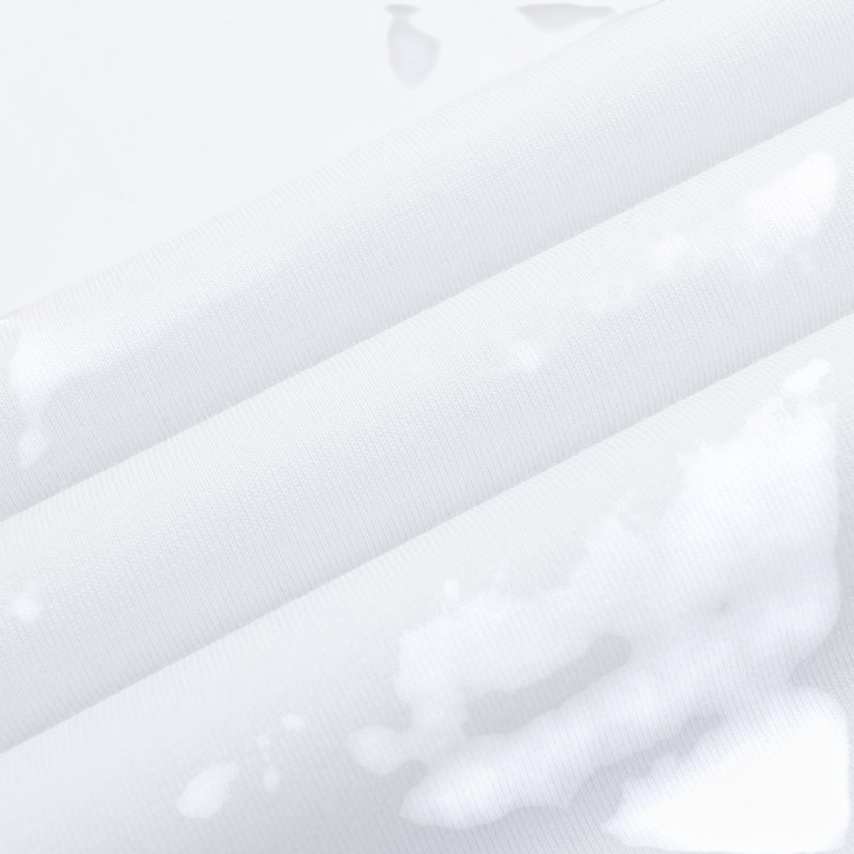 Close-up of FRG SS TEE white cotton fabric showing smooth texture and soft folds
