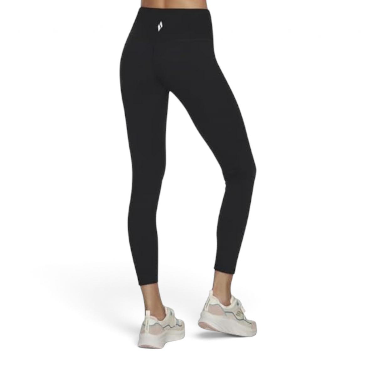 FRG black high-waisted leggings with a scalloped waistband detail worn by a model with white athletic sneakers
