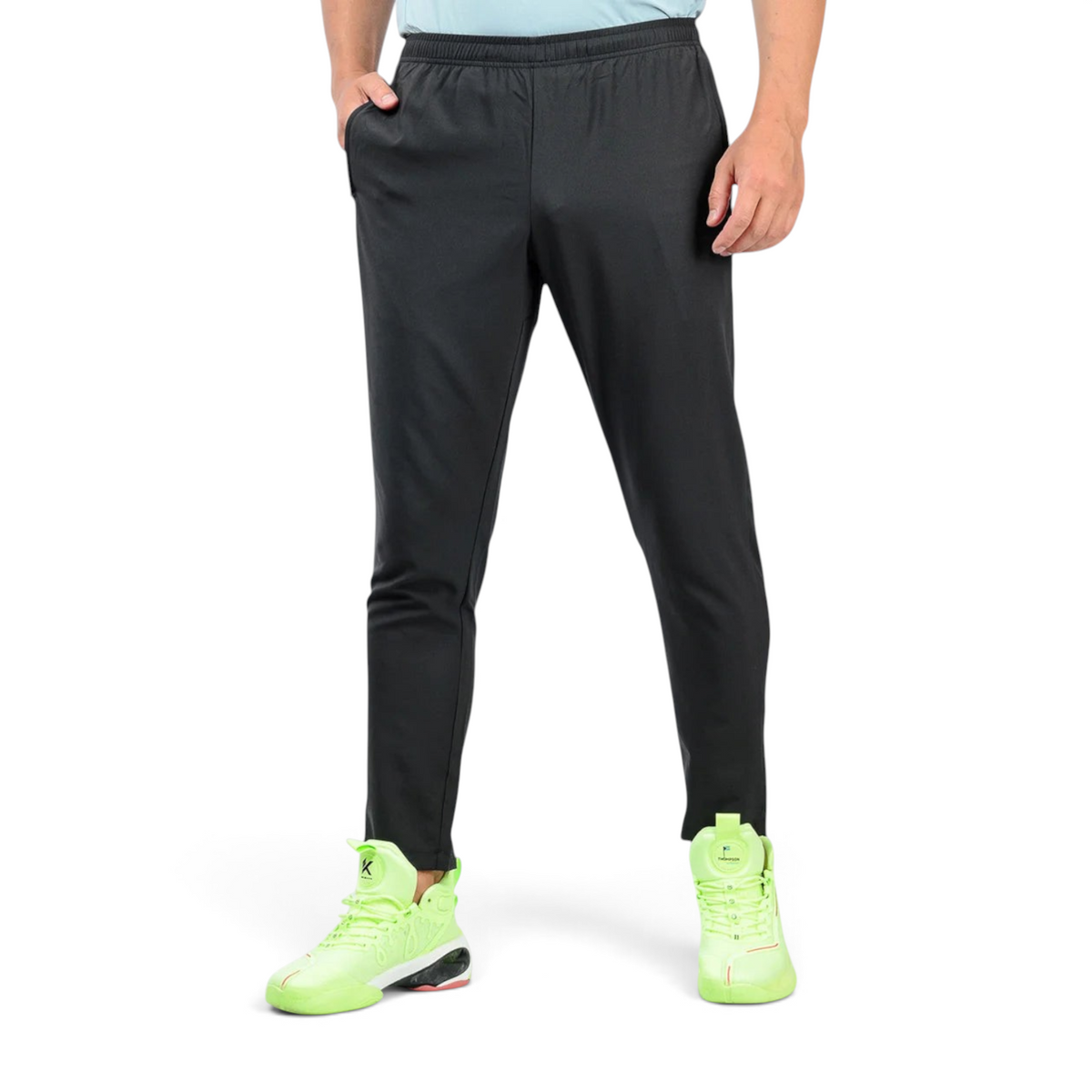 FRG black ankle pants on a man wearing bright neon green athletic sneakers