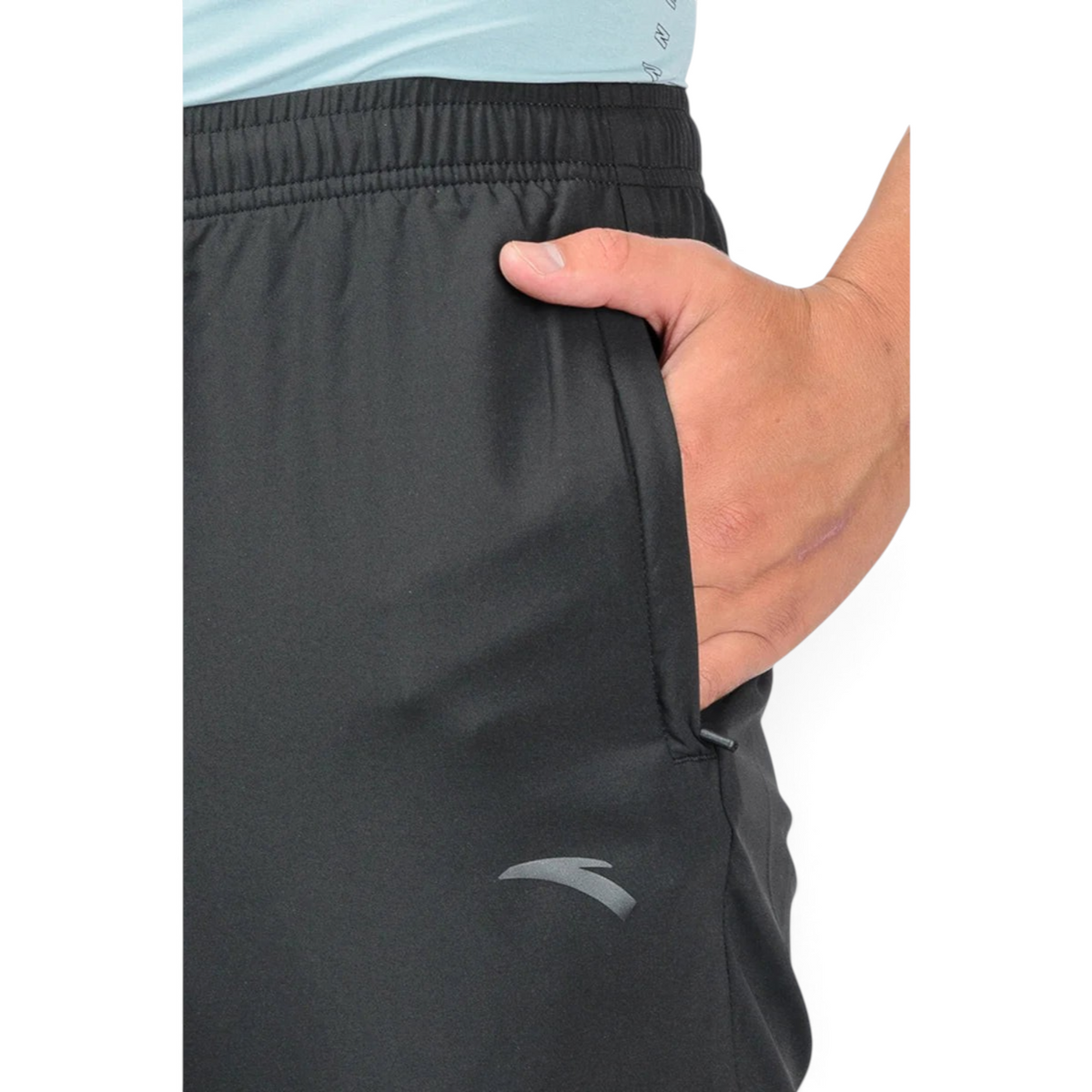FRG black athletic ankle pants featuring a side pocket and a subtle grey logo detail on a model