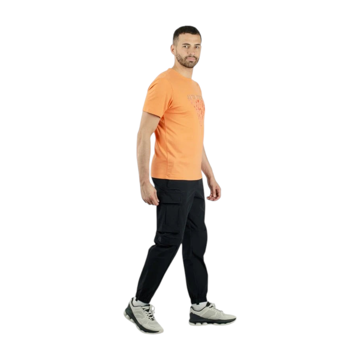 FRG Anta training t-shirt in orange with a bold chest print, worn by a man with black cargo pants and sneakers.