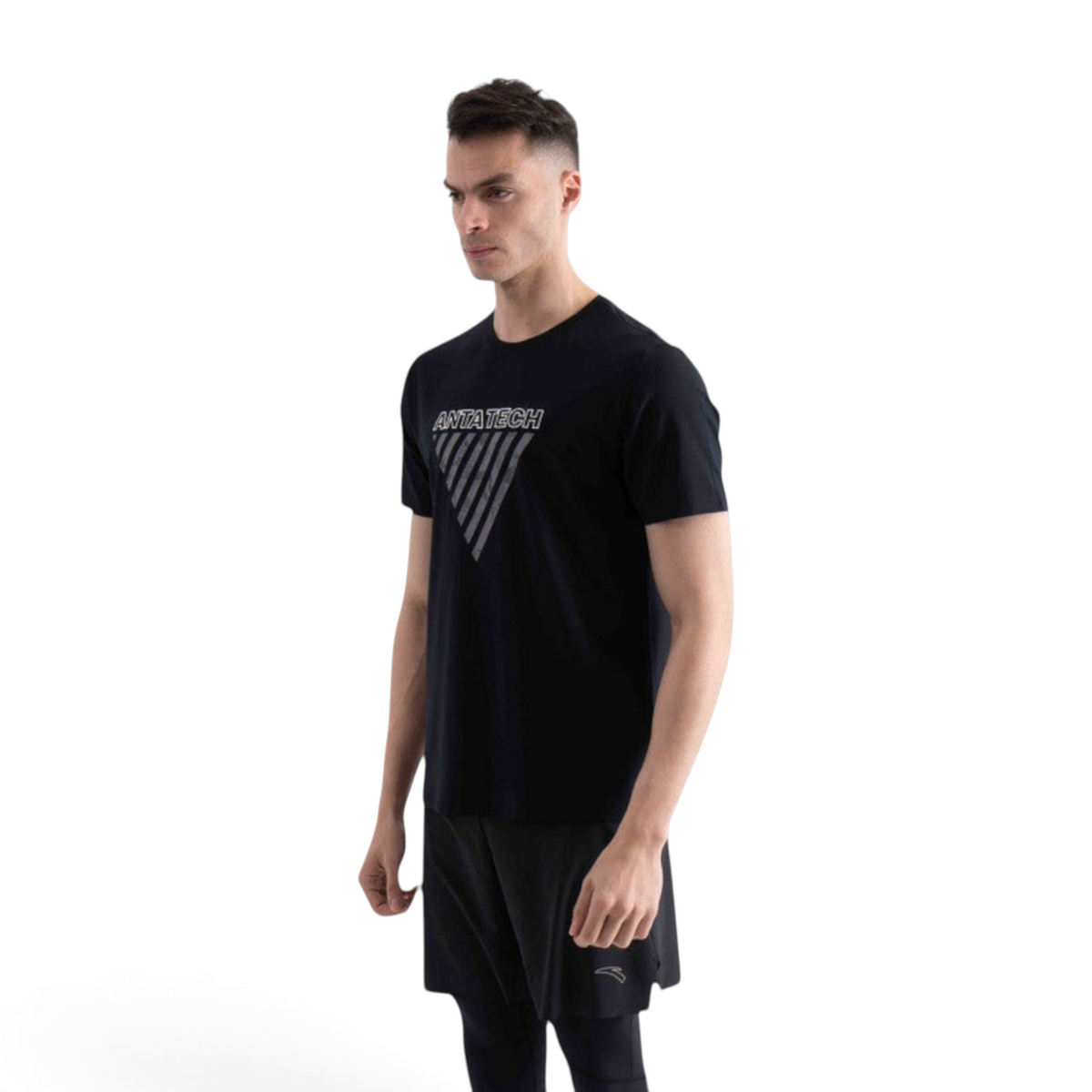 FRG SS TEE in black featuring a white ANTA TECH graphic print on the chest worn by a male model
