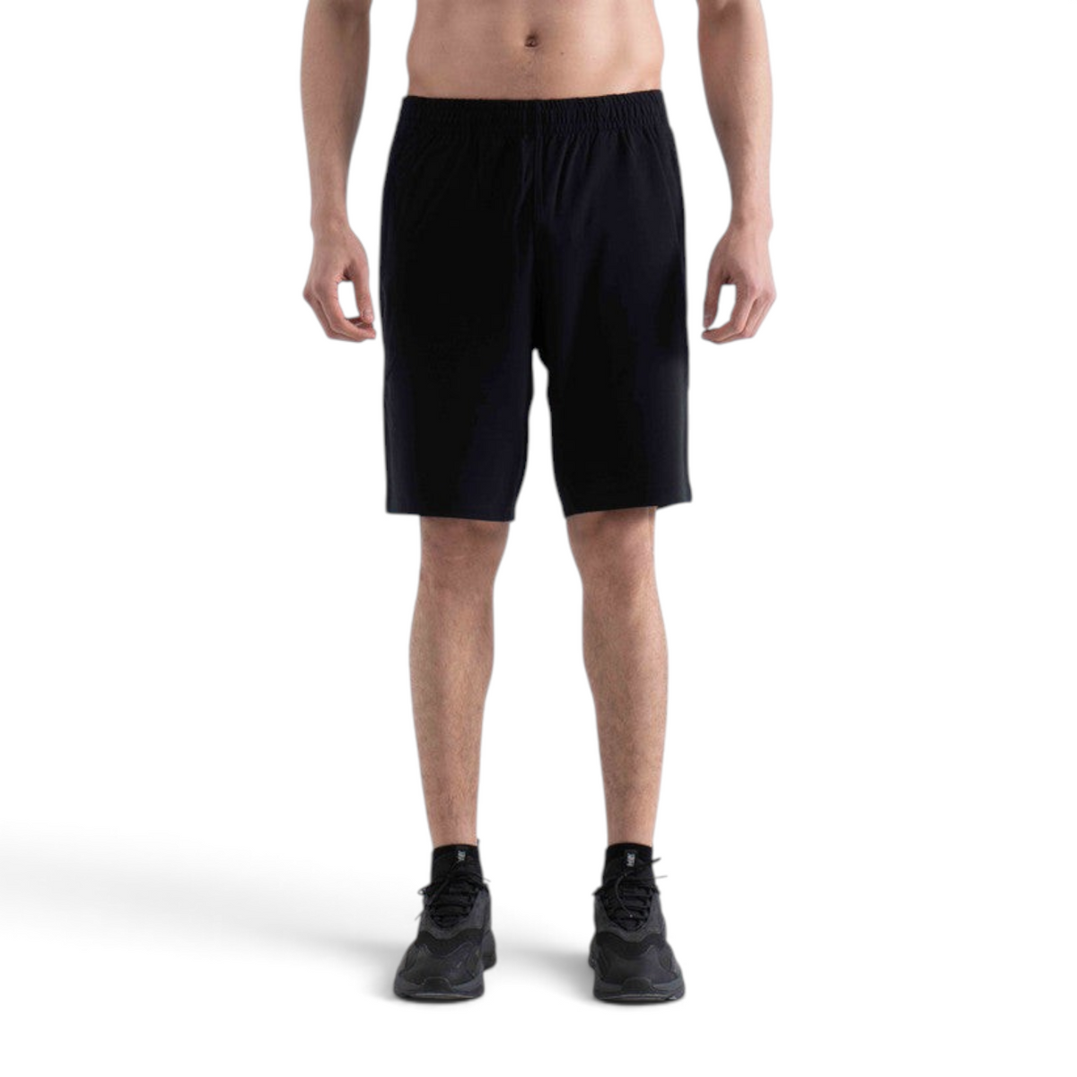 FRG black knit half pants featuring an elastic waistband worn by a man against a white background