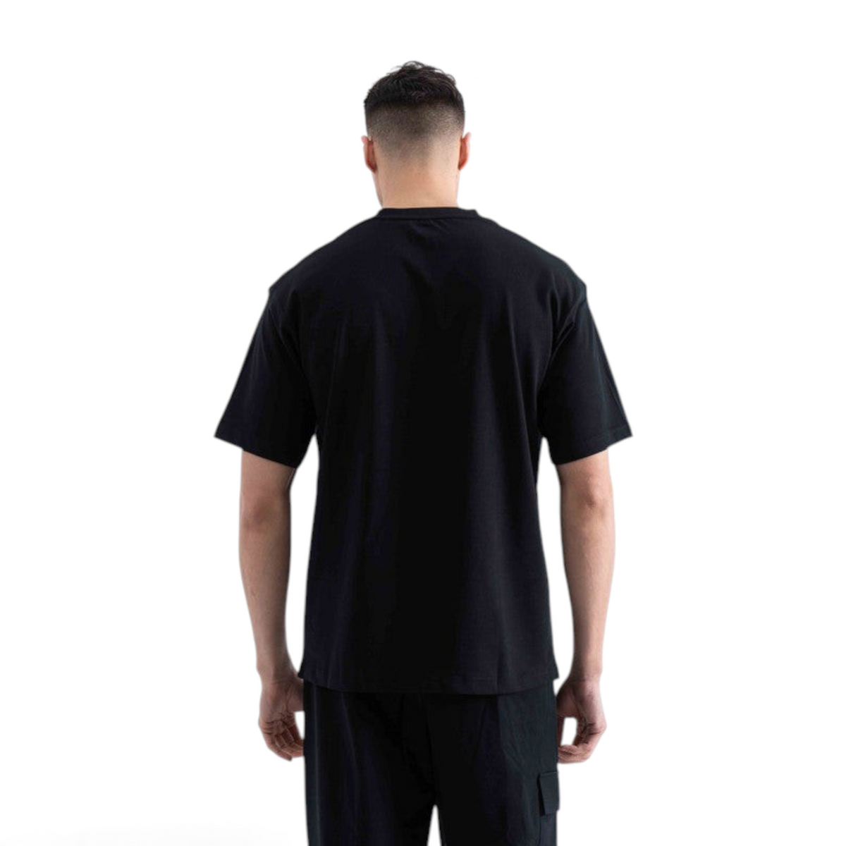 Back view of a man wearing a plain black short-sleeve crew neck t-shirt by FRG against a white background.
