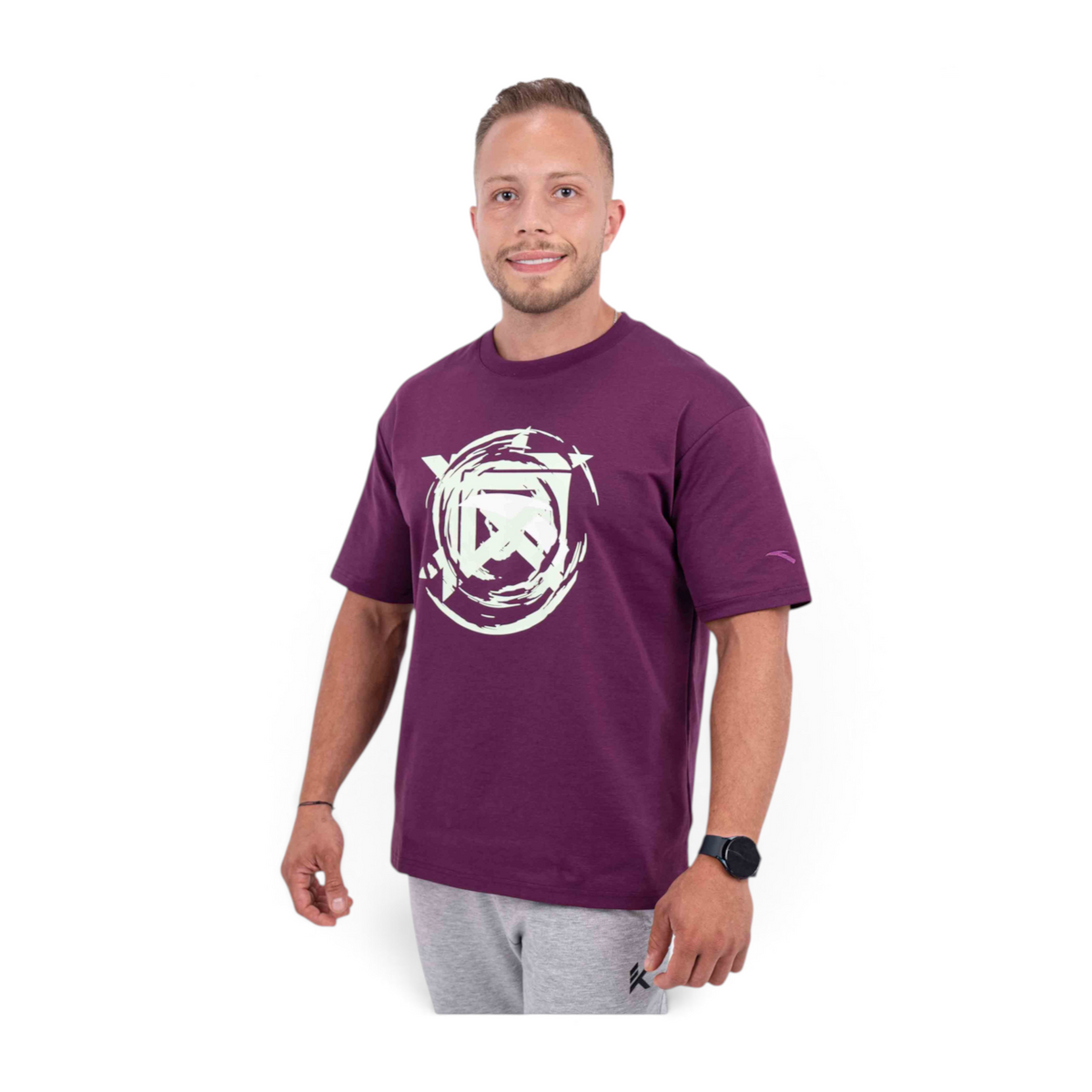 A man wearing a deep purple FRG crew neck t-shirt with a white circular graphic print on the chest.