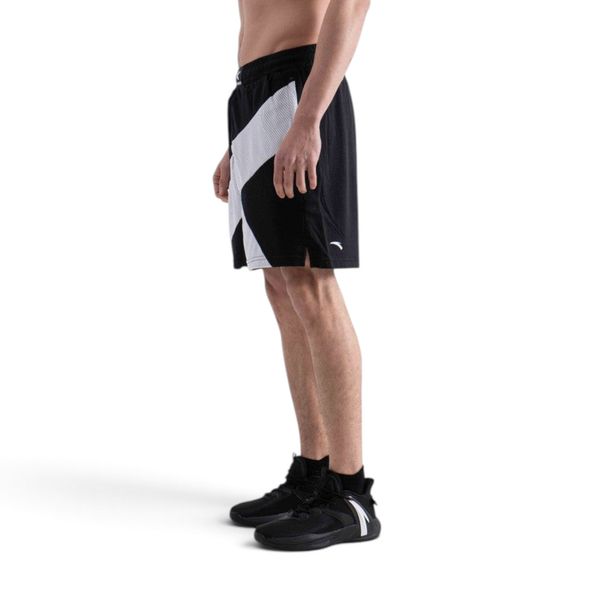 FRG men's black and white basketball game shorts with mesh fabric, side view on a model