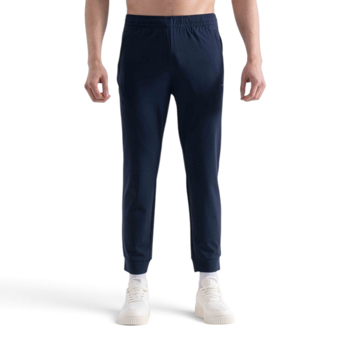 FRG slim fit navy blue knit ankle pants with an elastic waistband worn by a model with white sneakers
