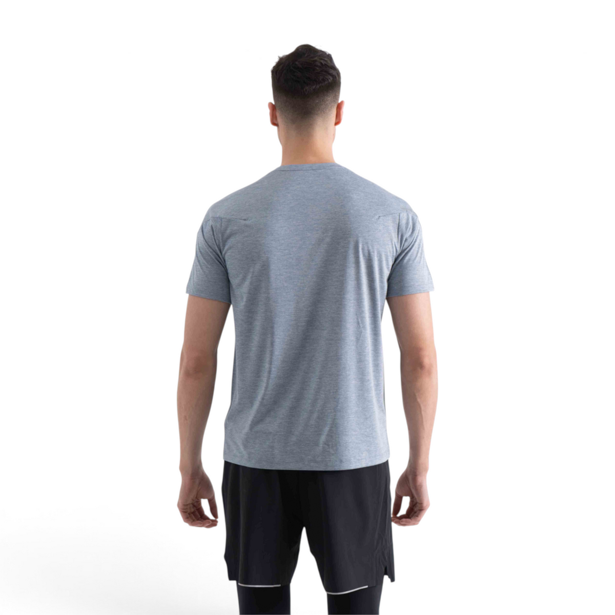 Back view of a man wearing a grey FRG short sleeve crew neck t-shirt paired with black athletic shorts