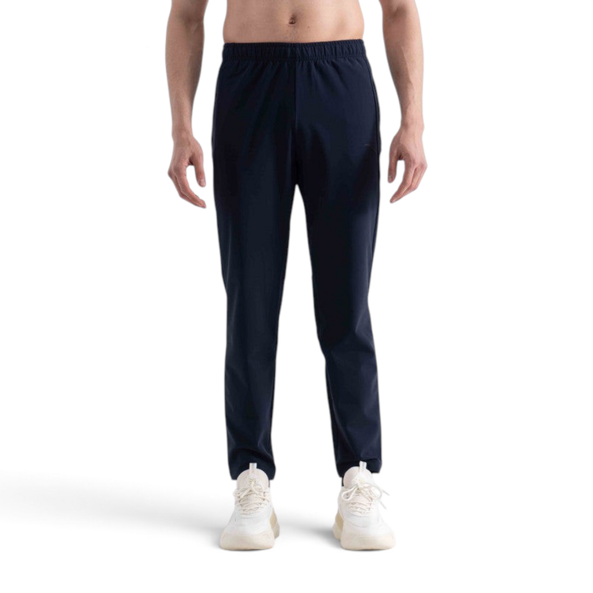 FRG navy blue knit track pants with an elastic waistband worn by a model with white sneakers