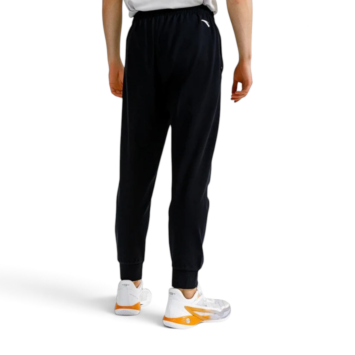 FRG ANTA black basketball knit track pants on a model, showing a comfortable fit with cuffed ankles from the back.