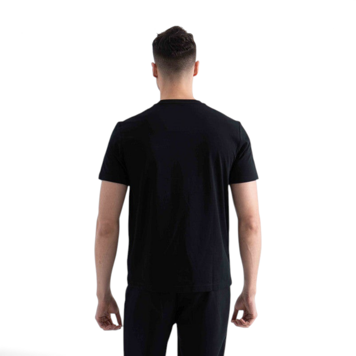 Back view of a man wearing a plain black short-sleeve FRG t-shirt against a white background