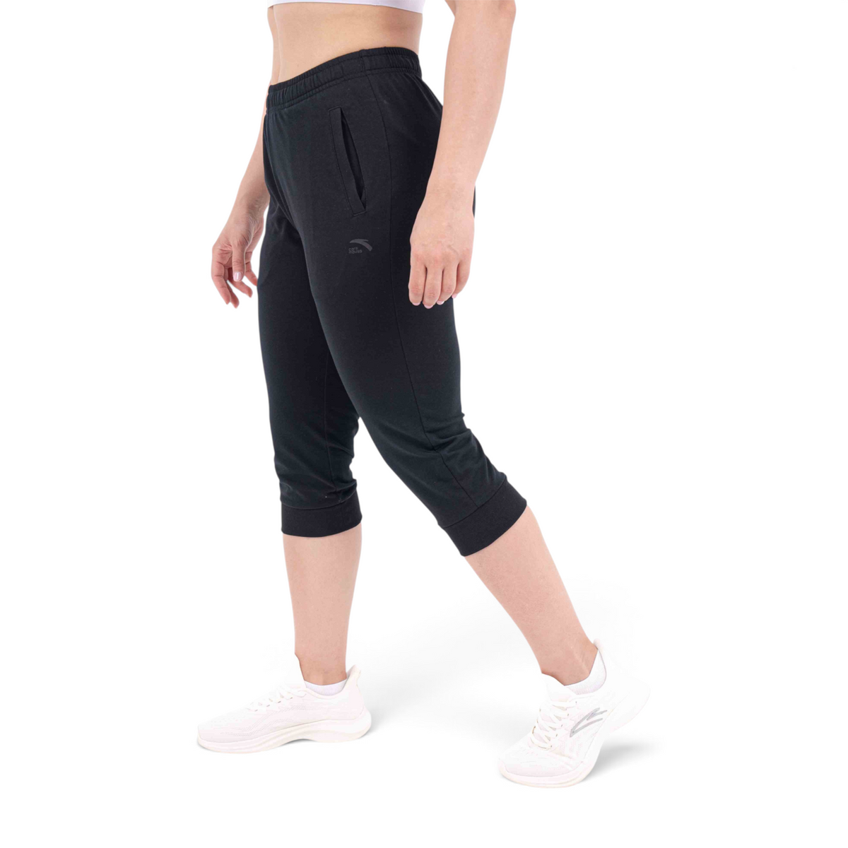 FRG Anta regular fit black cotton blend capri pants worn by a woman with white sneakers