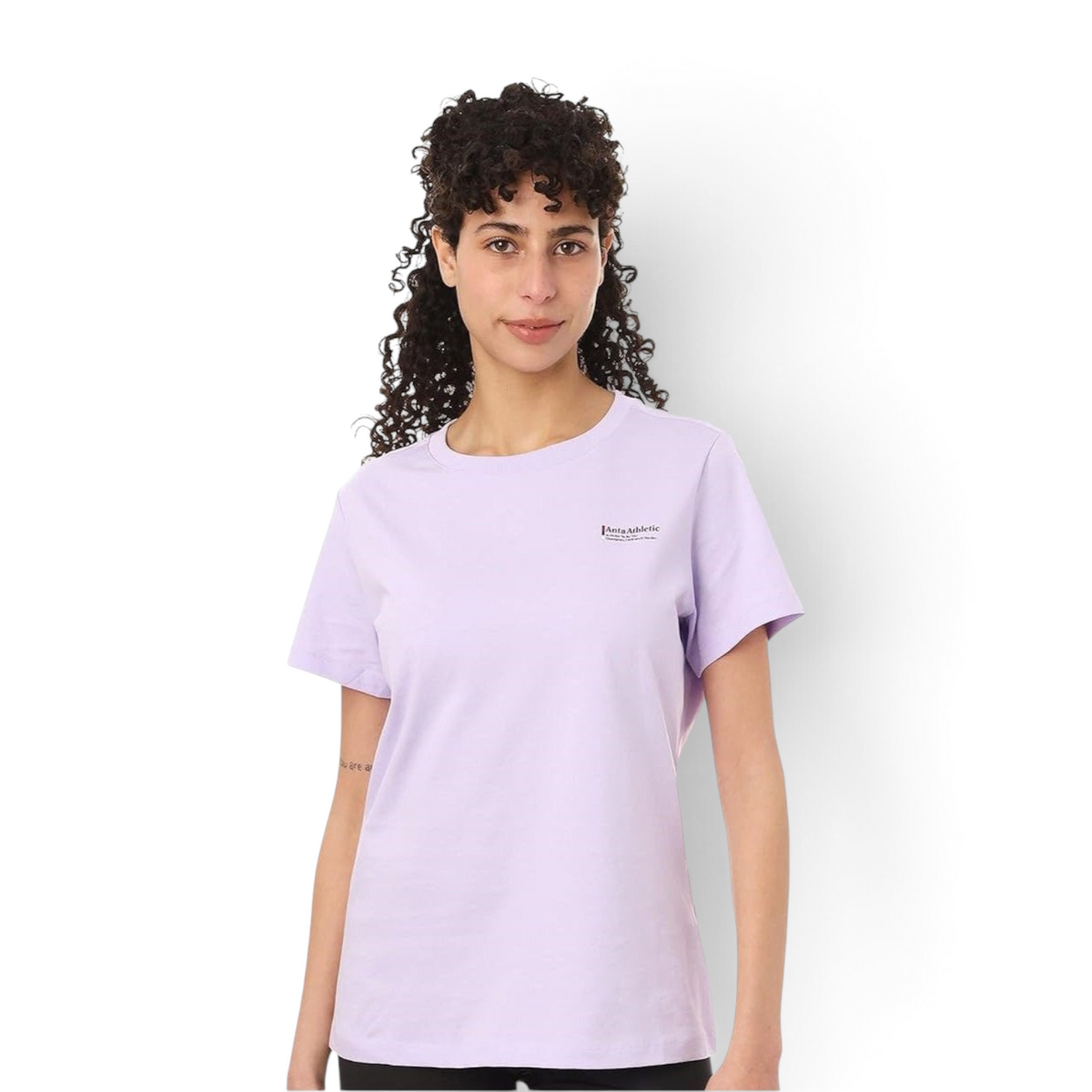 A woman wearing a light purple FRG crew neck T-shirt with a small logo on the chest against a white background