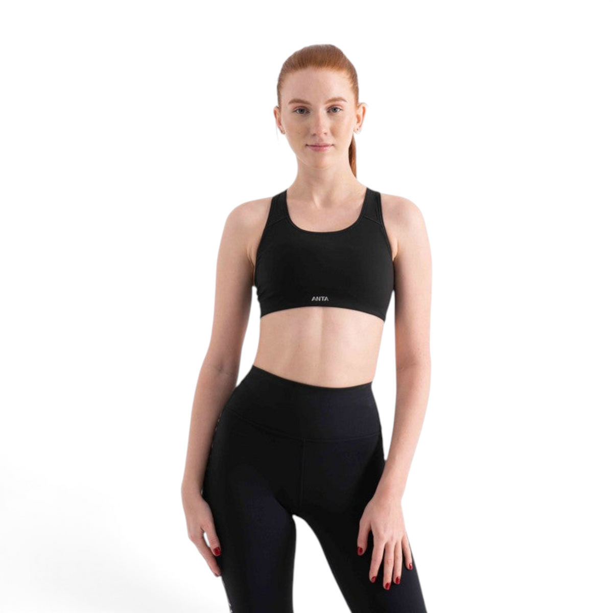 FRG model wearing a black athletic sports bra with a racerback design against a white studio background