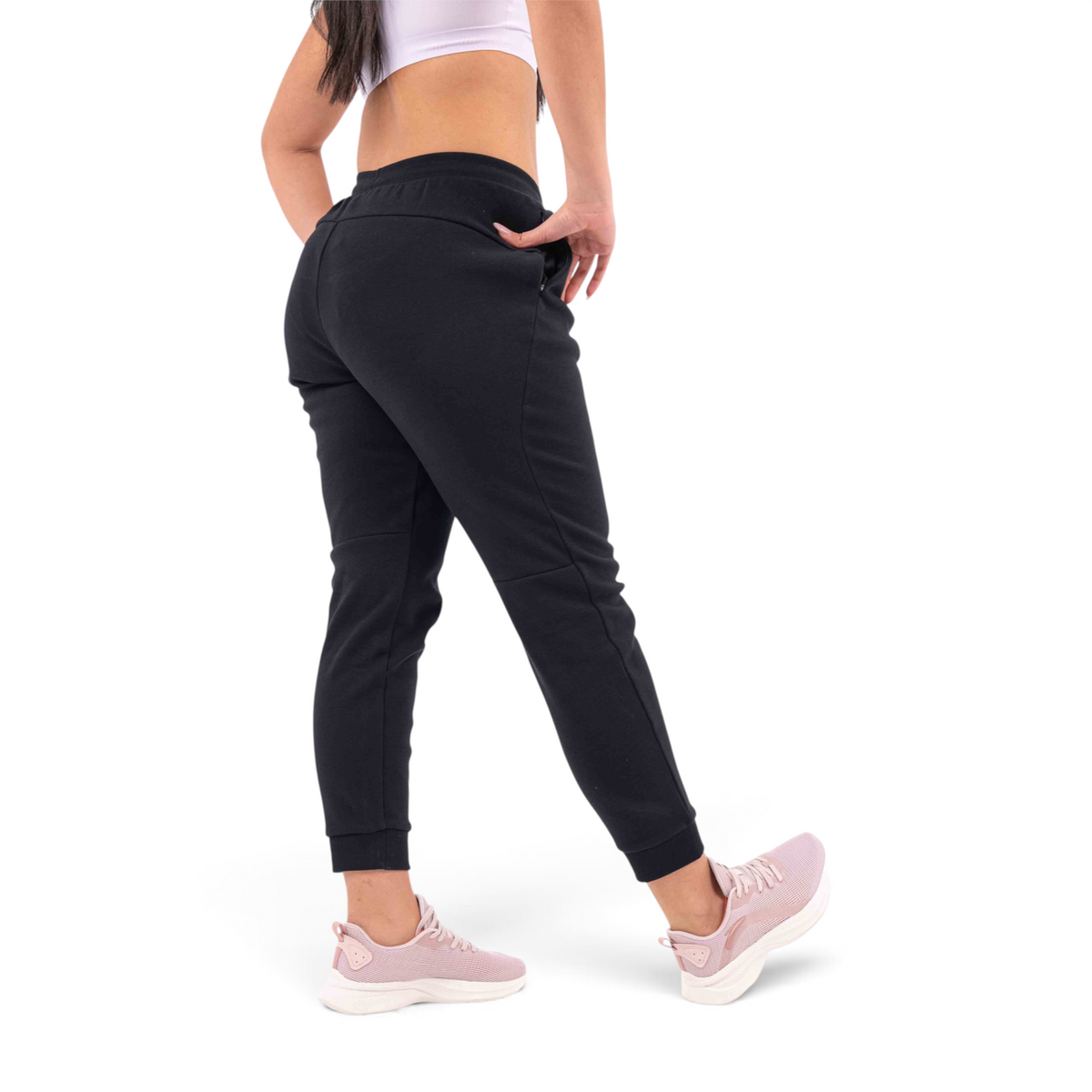 FRG black regular fit knit track pants with elastic cuffs worn by a woman from a rear angle view