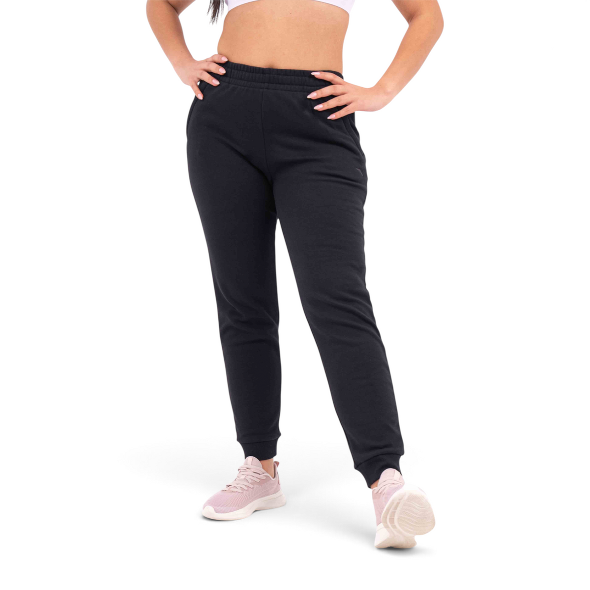 FRG black regular fit knit track pants made from a polyester cotton blend worn by a model with pink sneakers
