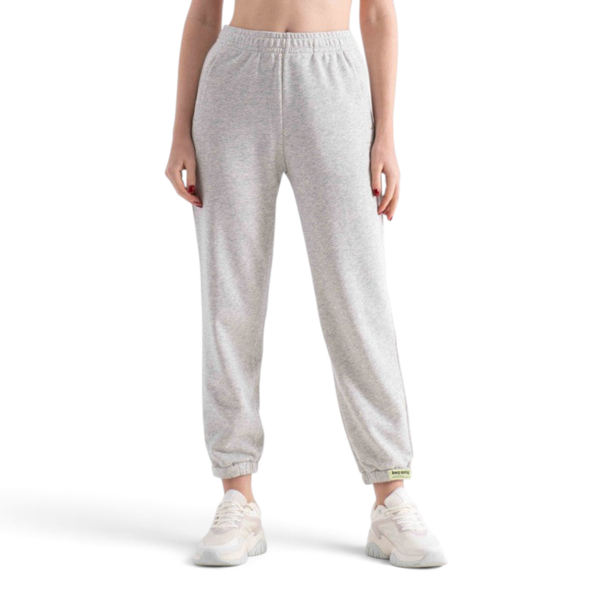 FRG knit track pants in light grey with an elasticated waistband and cuffed ankles worn with white sneakers