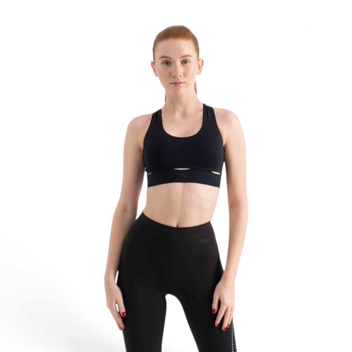 FRG black athletic sports bra with cutout detail worn by a red-haired model against a white background
