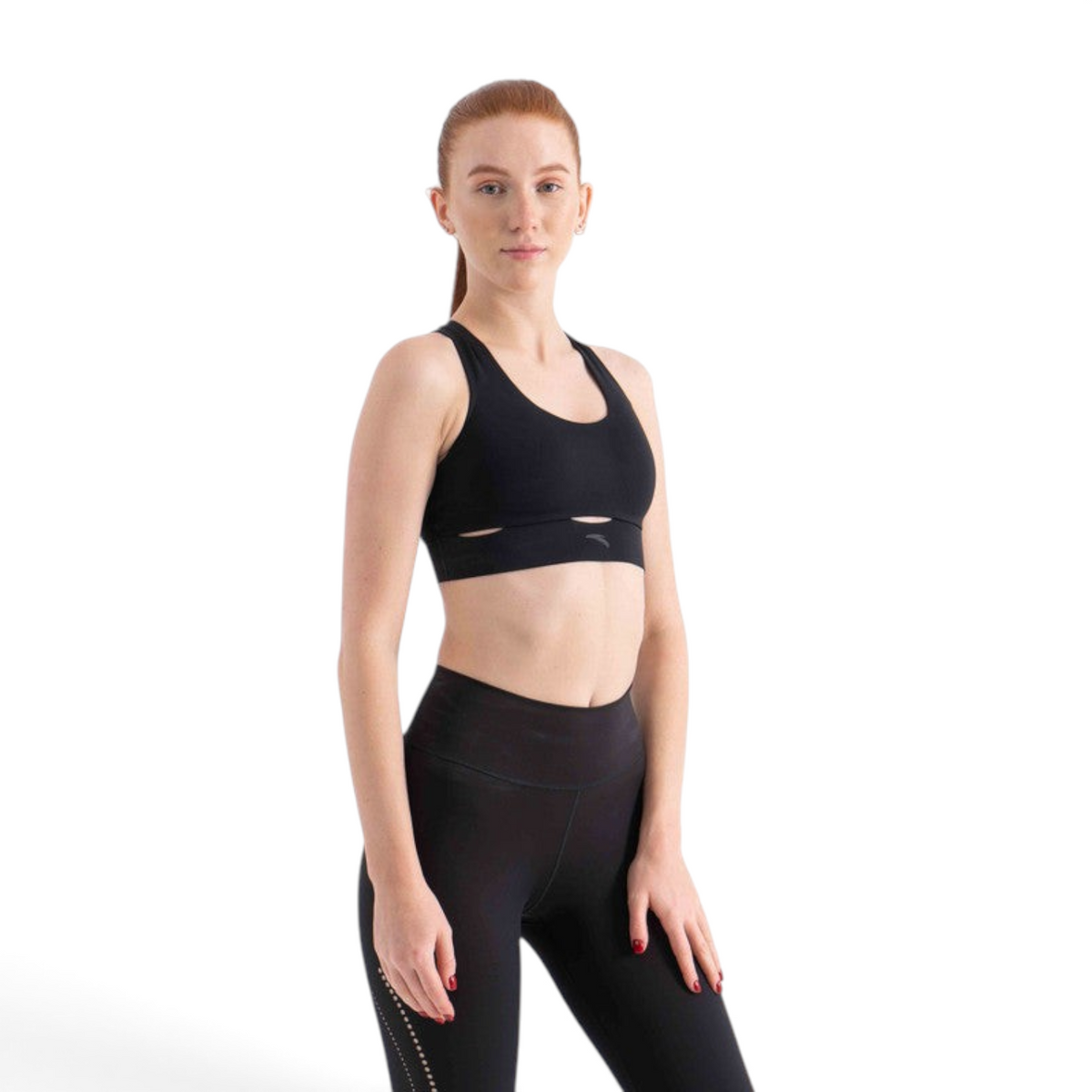 FRG black athletic sports bra with a cutout detail worn by a woman against a white background