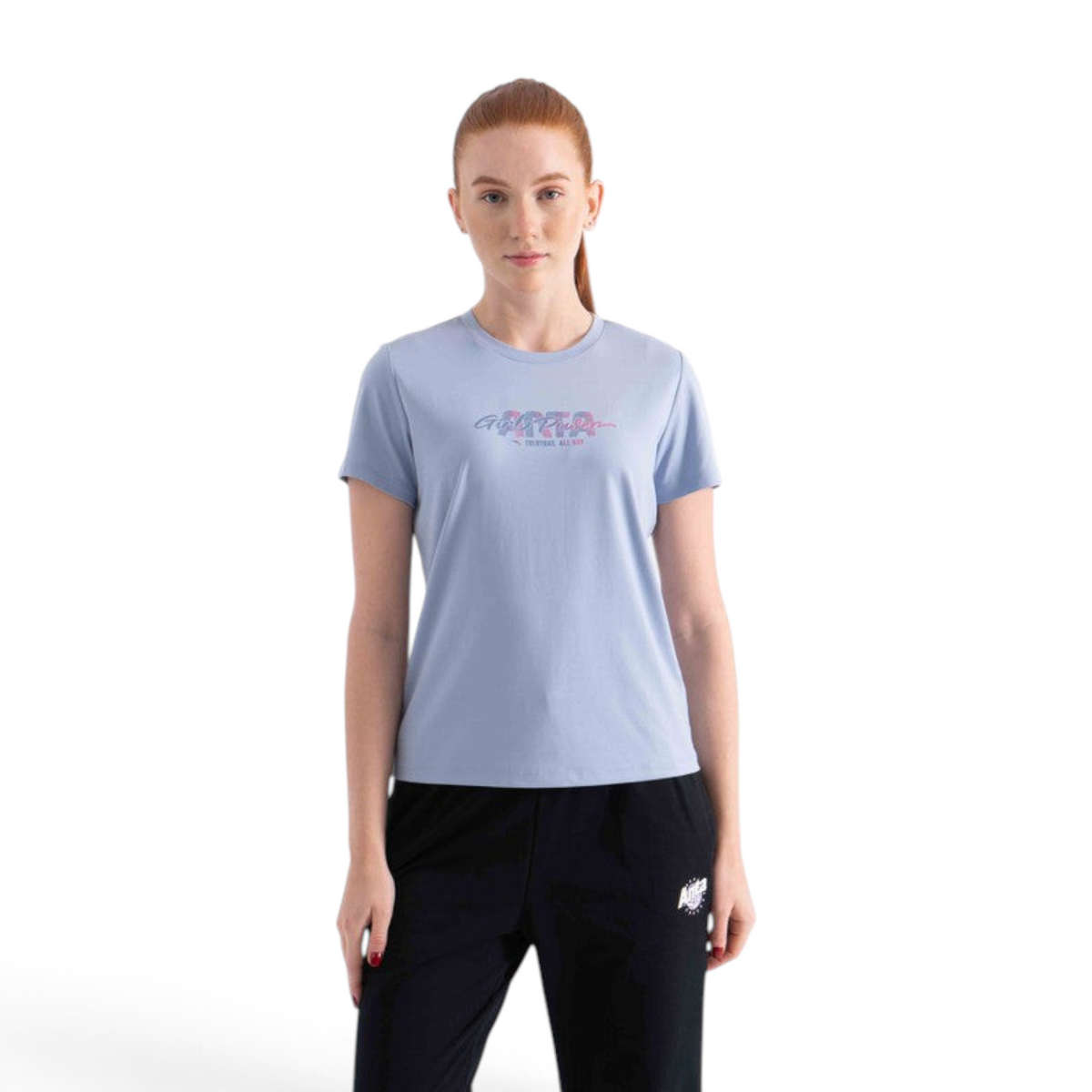 A woman wearing a light blue FRG short-sleeve crew neck t-shirt with a graphic print on the chest.