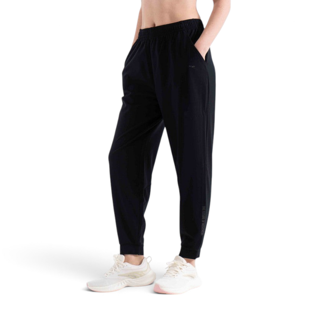 FRG black knit ankle pants with an elastic waistband and side pockets worn by a model with white athletic sneakers