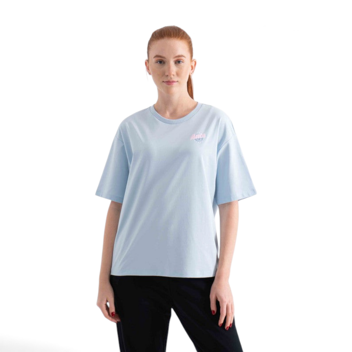 A woman wearing a light blue FRG short-sleeve cotton t-shirt with a small pink logo on the chest.