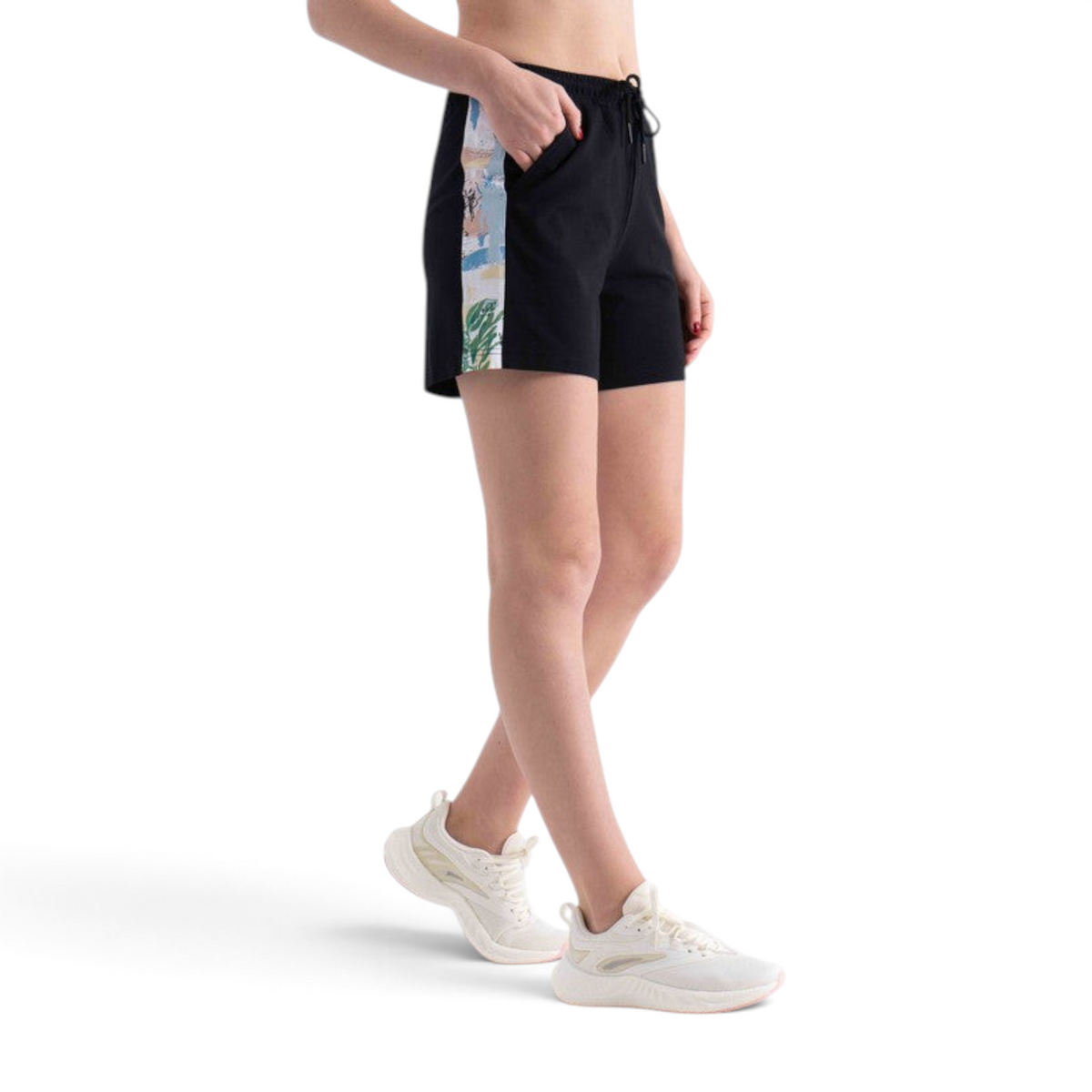 FRG black knit shorts featuring a side panel with a colorful abstract print, worn by a model in white sneakers