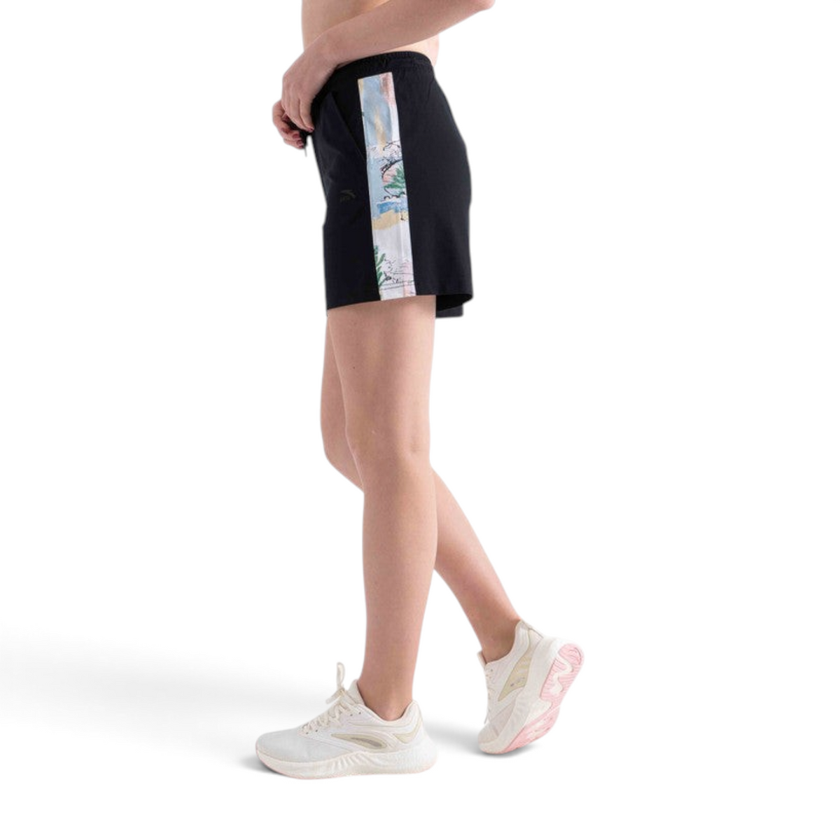 FRG black knit shorts with a floral side stripe panel worn by a model in white athletic sneakers
