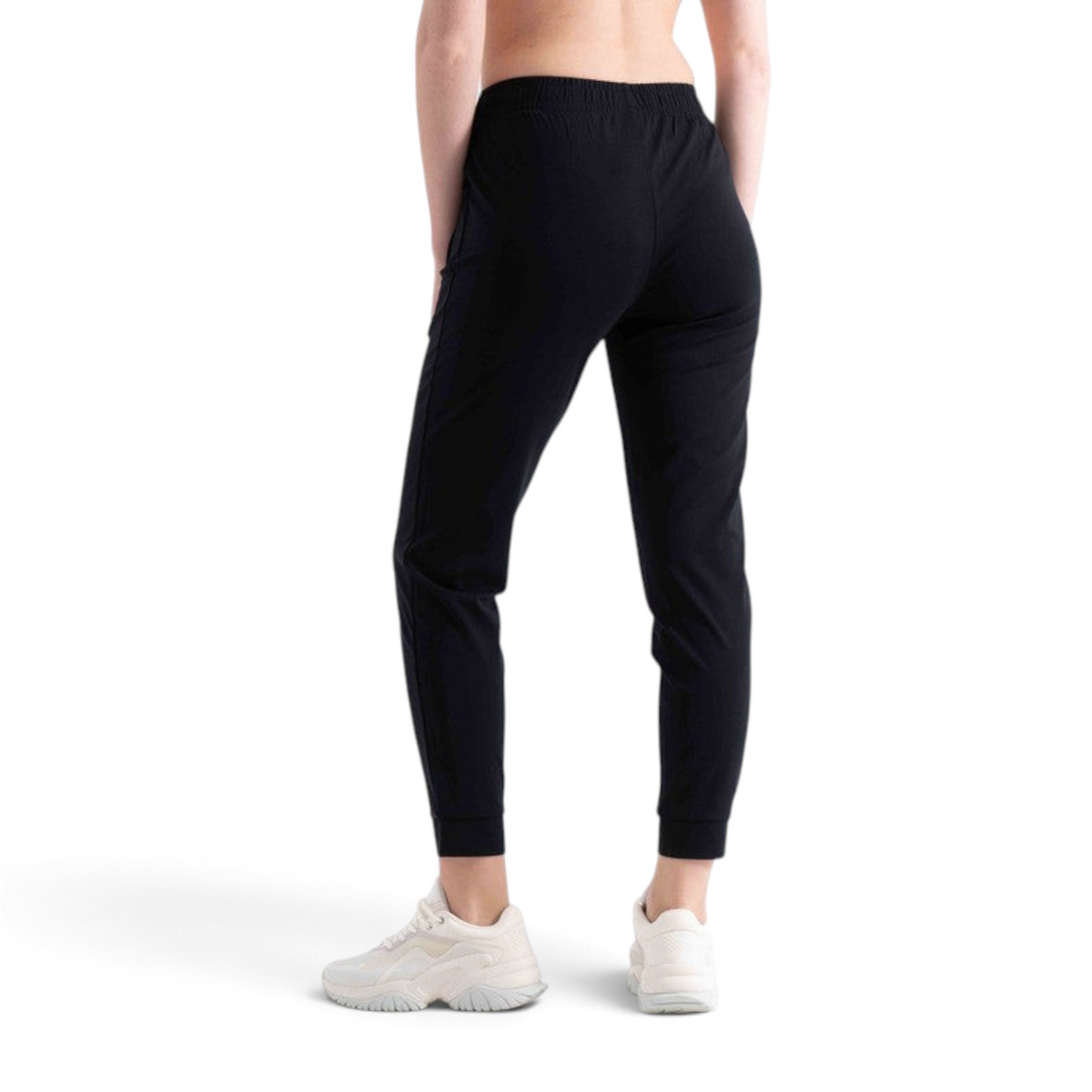 FRG black knit track pants with an elastic waistband and cuffed ankles, worn by a model from the back view
