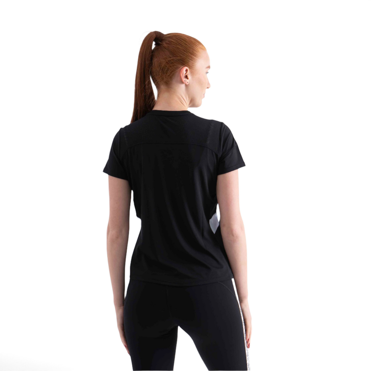 Woman wearing a black FRG SS TEE with mesh back detailing, viewed from behind against a white background.