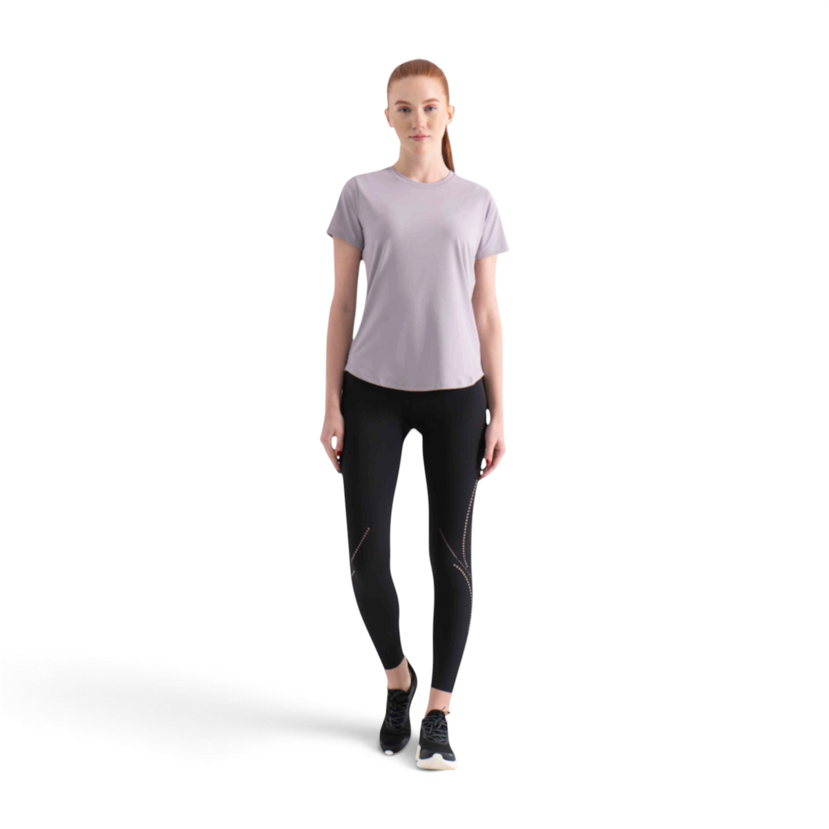 FRG short sleeve tee in light grey worn by a woman with black athletic leggings and sneakers