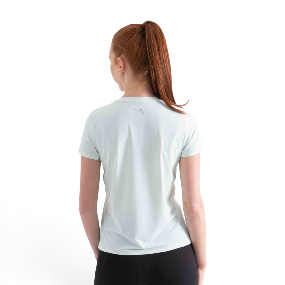 Back view of a woman wearing a light mint green FRG short sleeve athletic tee with a small logo on the upper back.