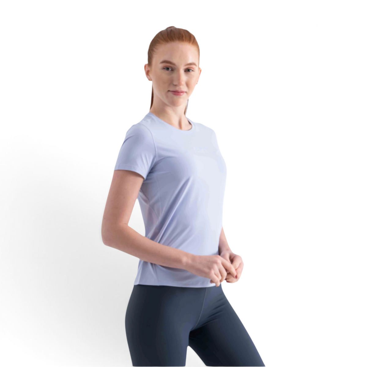 FRG SS TEE in light blue worn by a woman with red hair, featuring a crew neck and short sleeves for activewear.