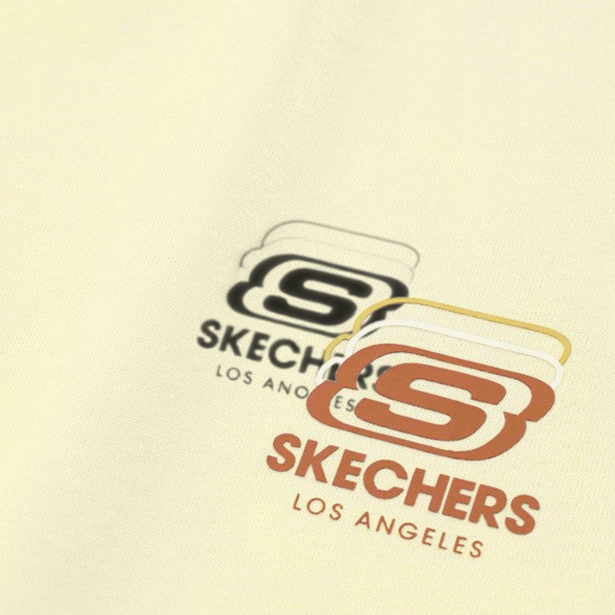 FRG lifestyle top in cream featuring a layered brown and tan Skechers Los Angeles logo graphic