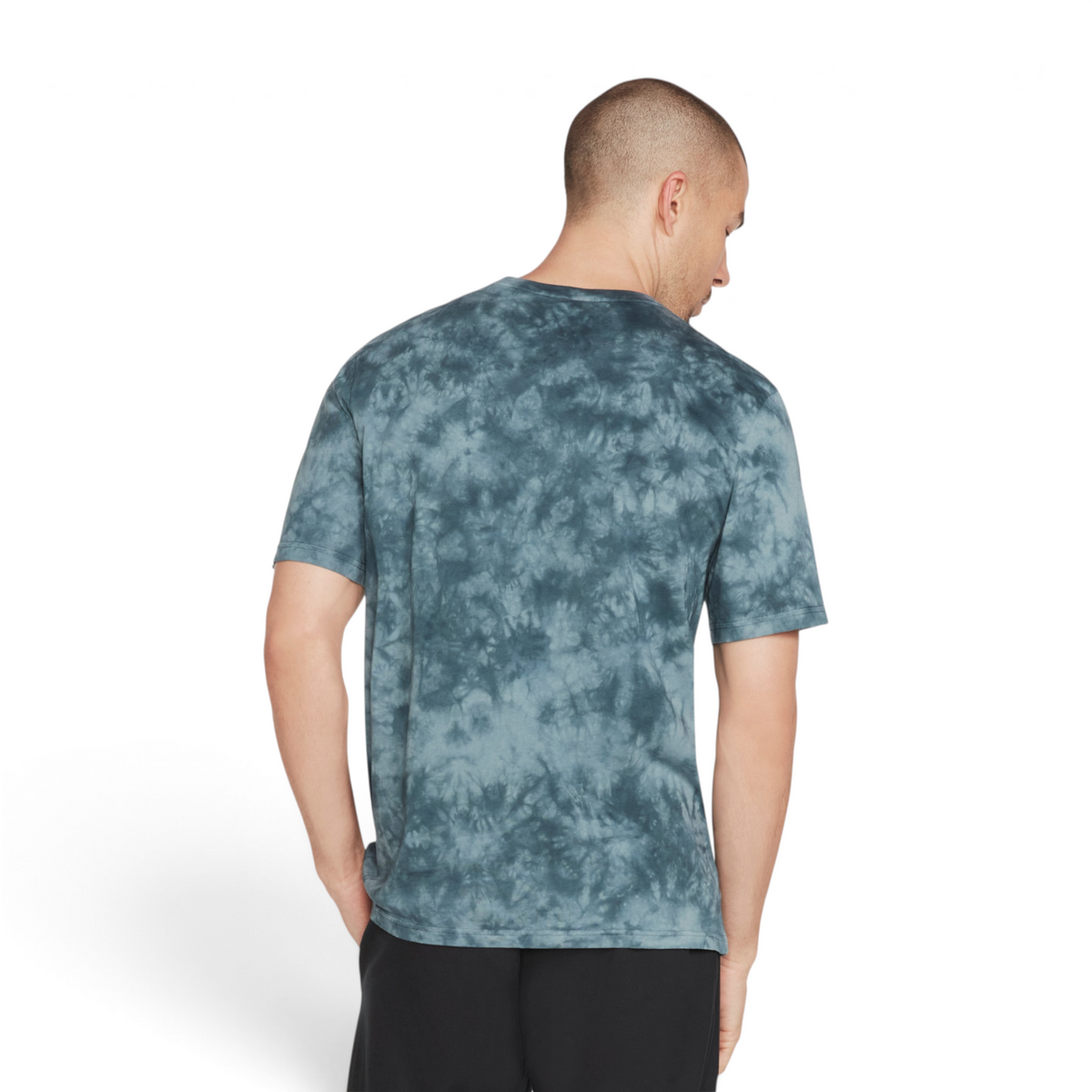 Back view of a man wearing a FRG blue and grey tie-dye 100% cotton knit t-shirt against a grey background.