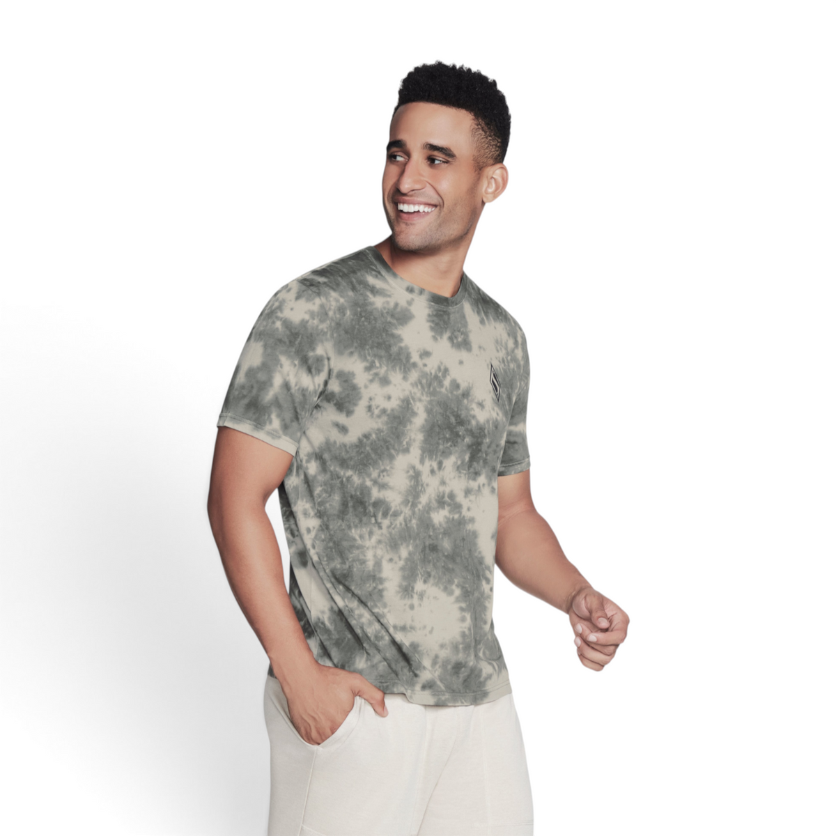 FRG men's olive green tie-dye cotton t-shirt worn by a smiling model against a light grey studio background.