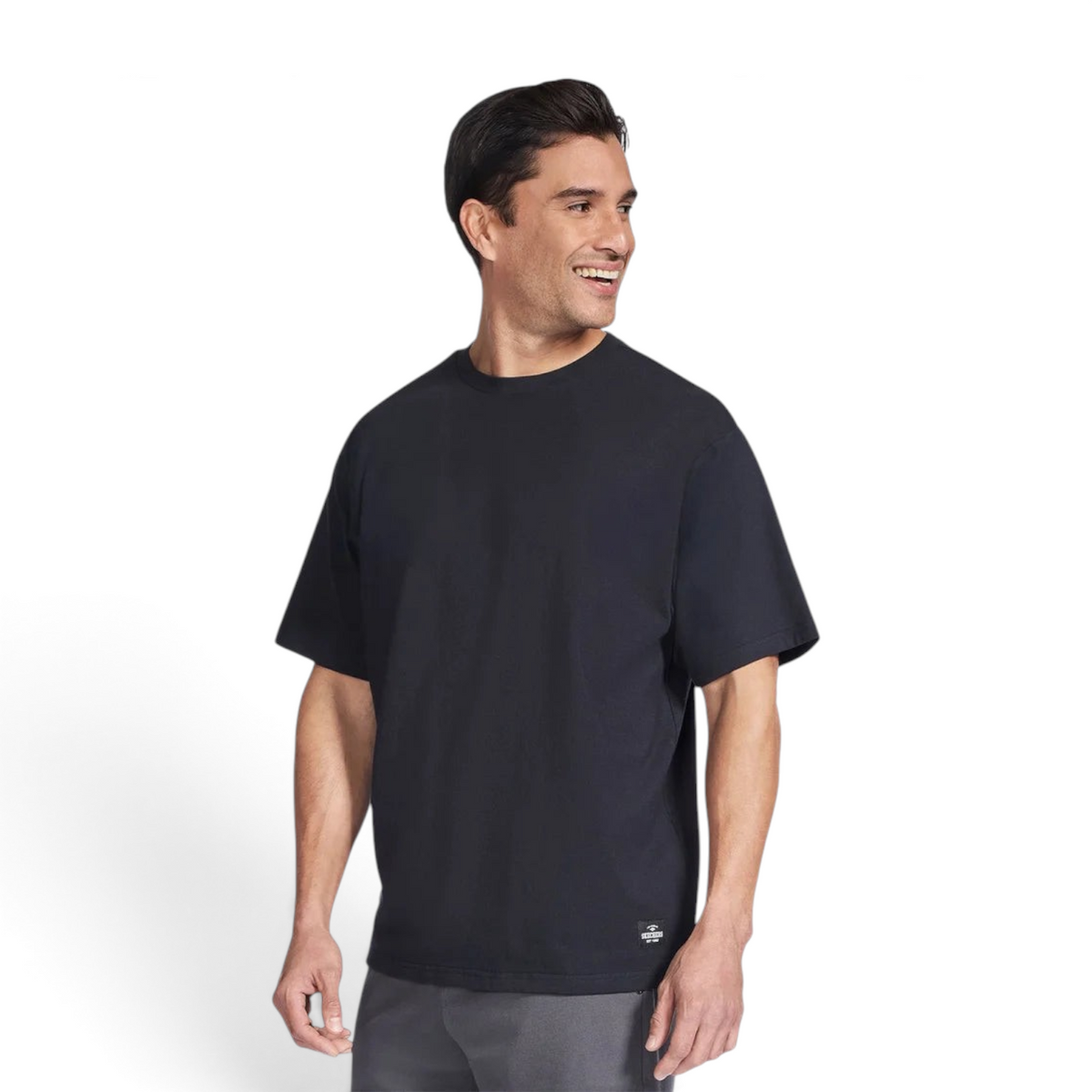 Man wearing a black Skechers JERSEY MAX short sleeve crew neck t-shirt with a small logo patch on the hem