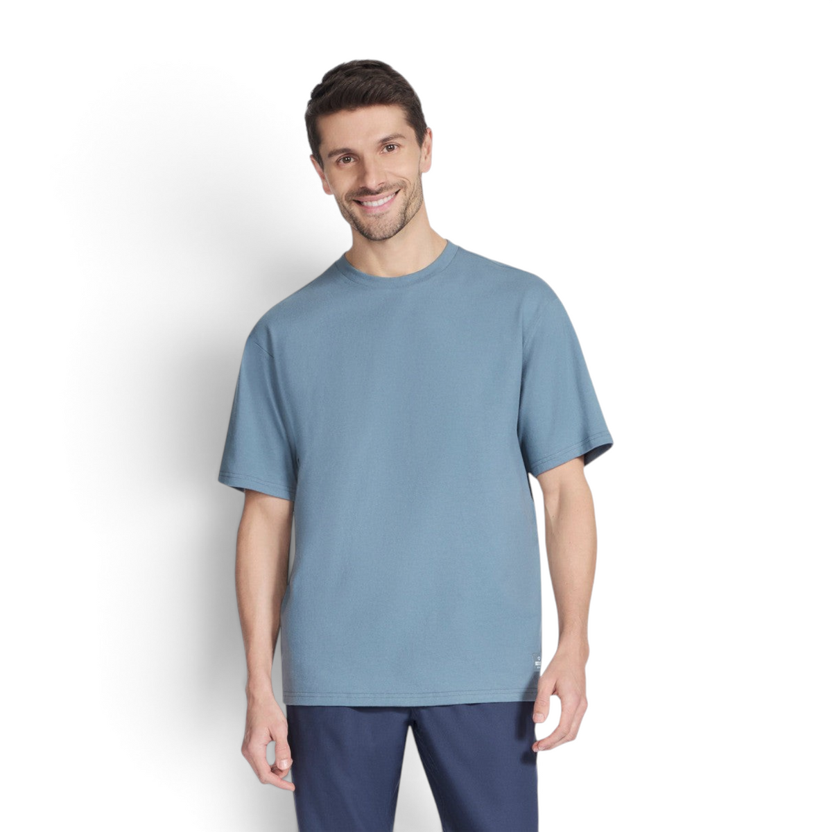 FRG SKECH-JERSEY MAX short sleeve t-shirt in dusty blue worn by a smiling man against a white background