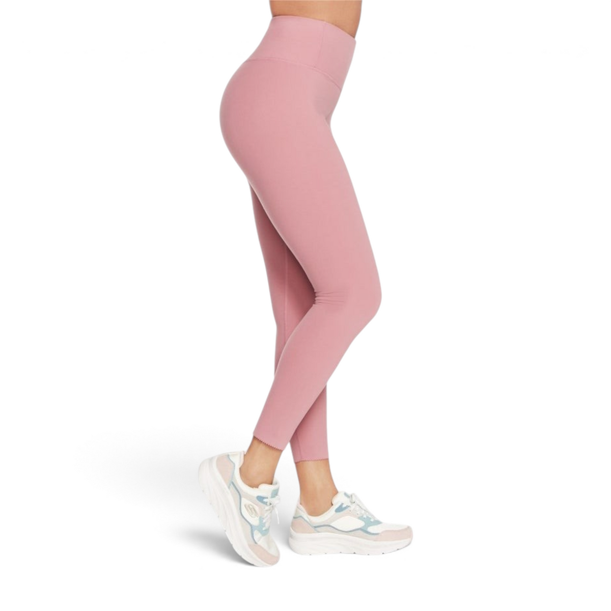 FRG high-waisted leggings in dusty pink with a subtle scalloped hem detail, worn with white athletic sneakers.
