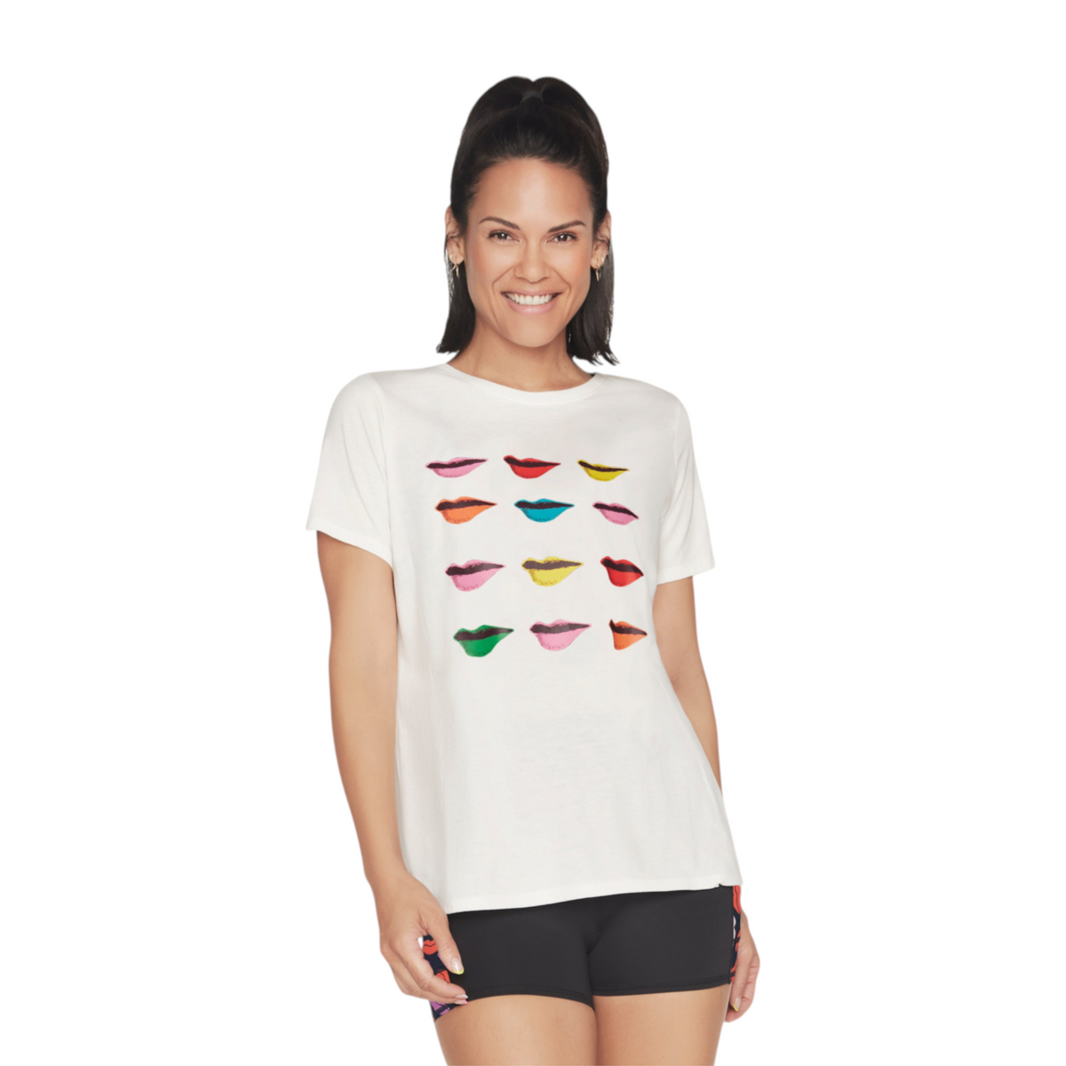 FRG DVF GODRI TEE in white featuring a colorful lips graphic print worn by a smiling woman