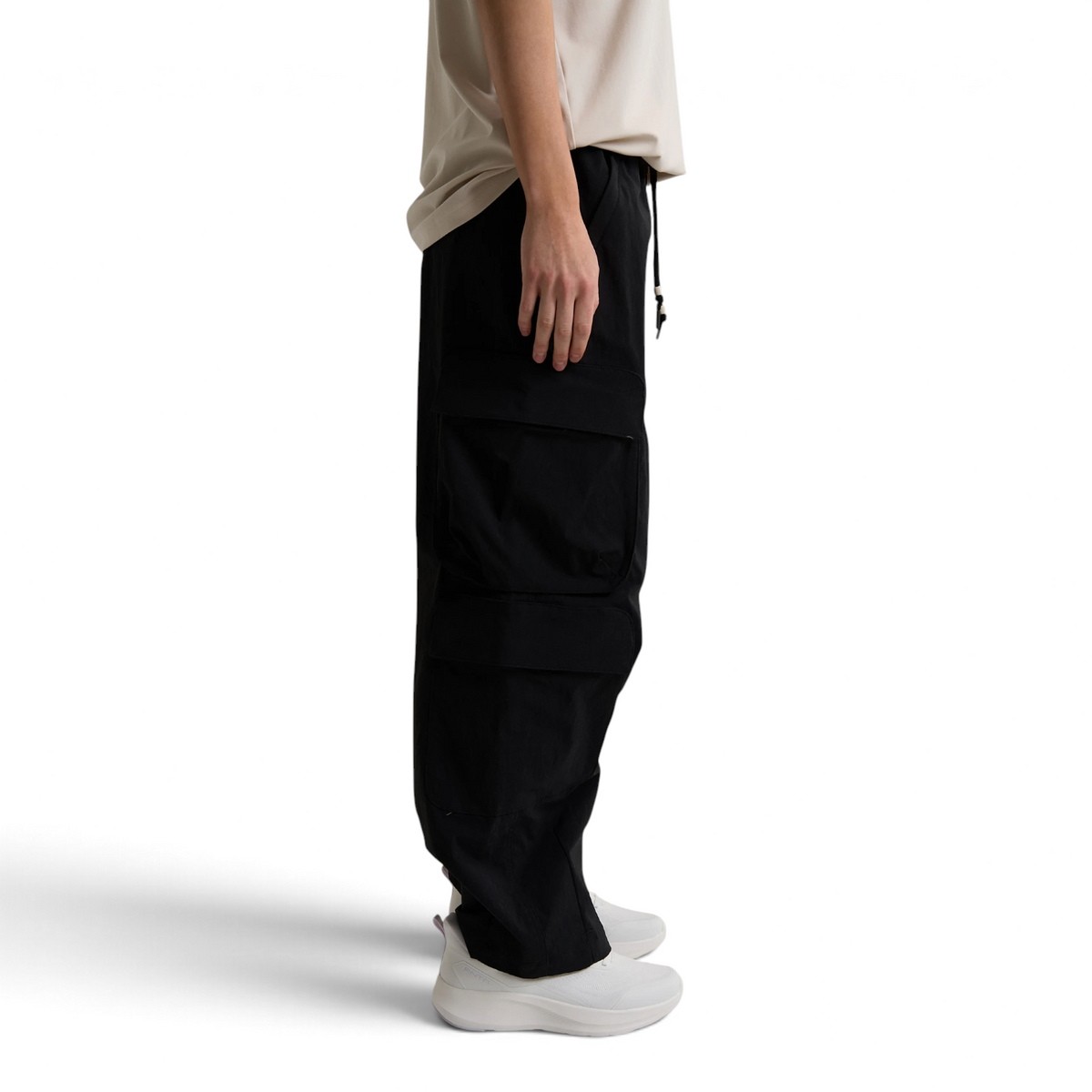 FRG ANTA black woven casual cargo pants with side pockets worn by a person in a studio setting