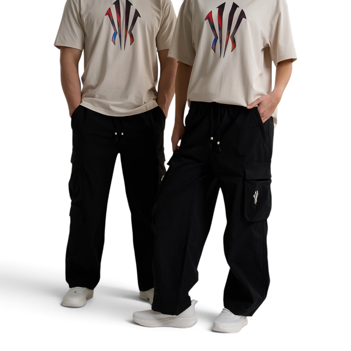 FRG ANTA black woven unisex cargo pants with drawstring waist and side pockets worn by two models