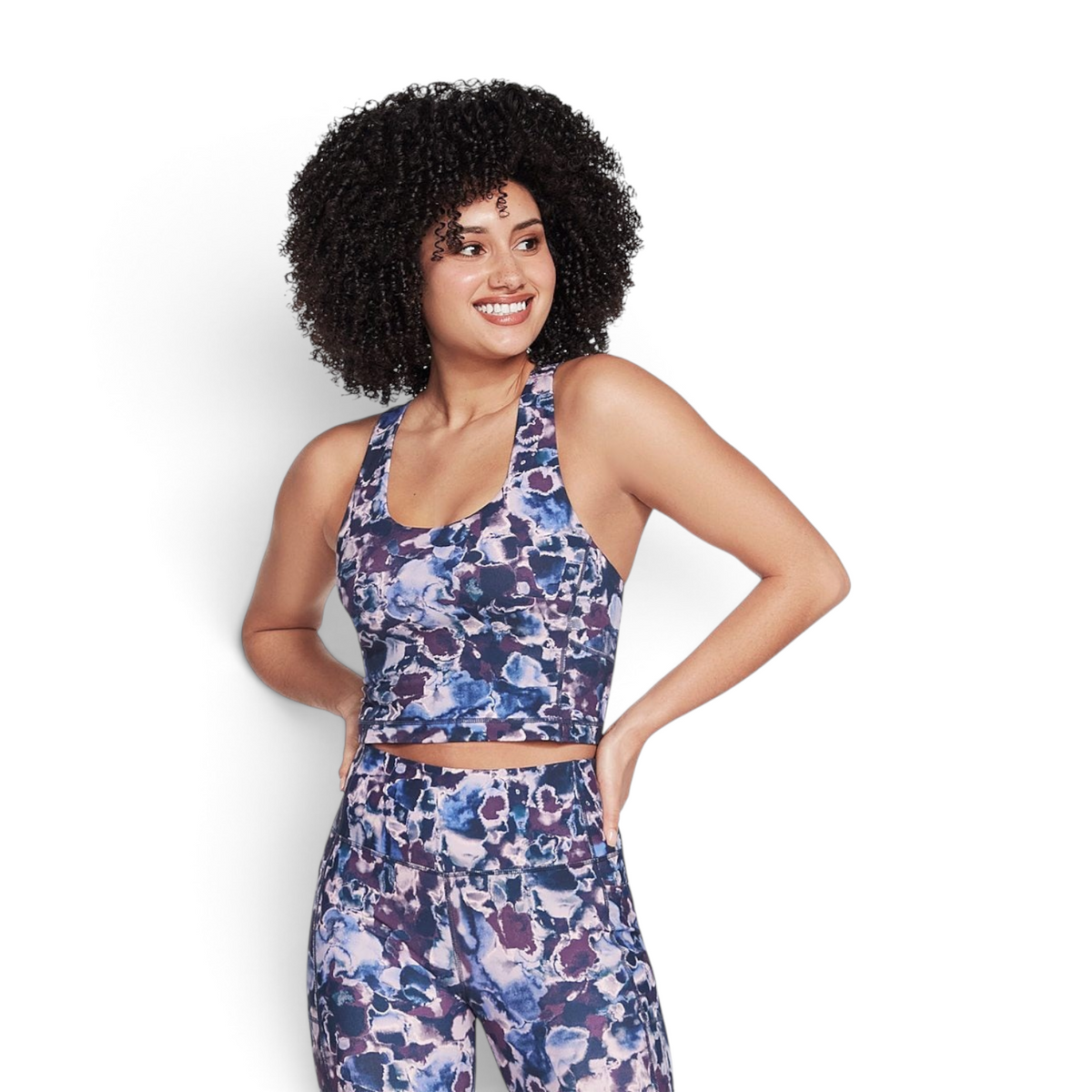 FRG THE GOWALK DIZZY FLORAL RACER crop top in blue and purple abstract floral print worn by a smiling model