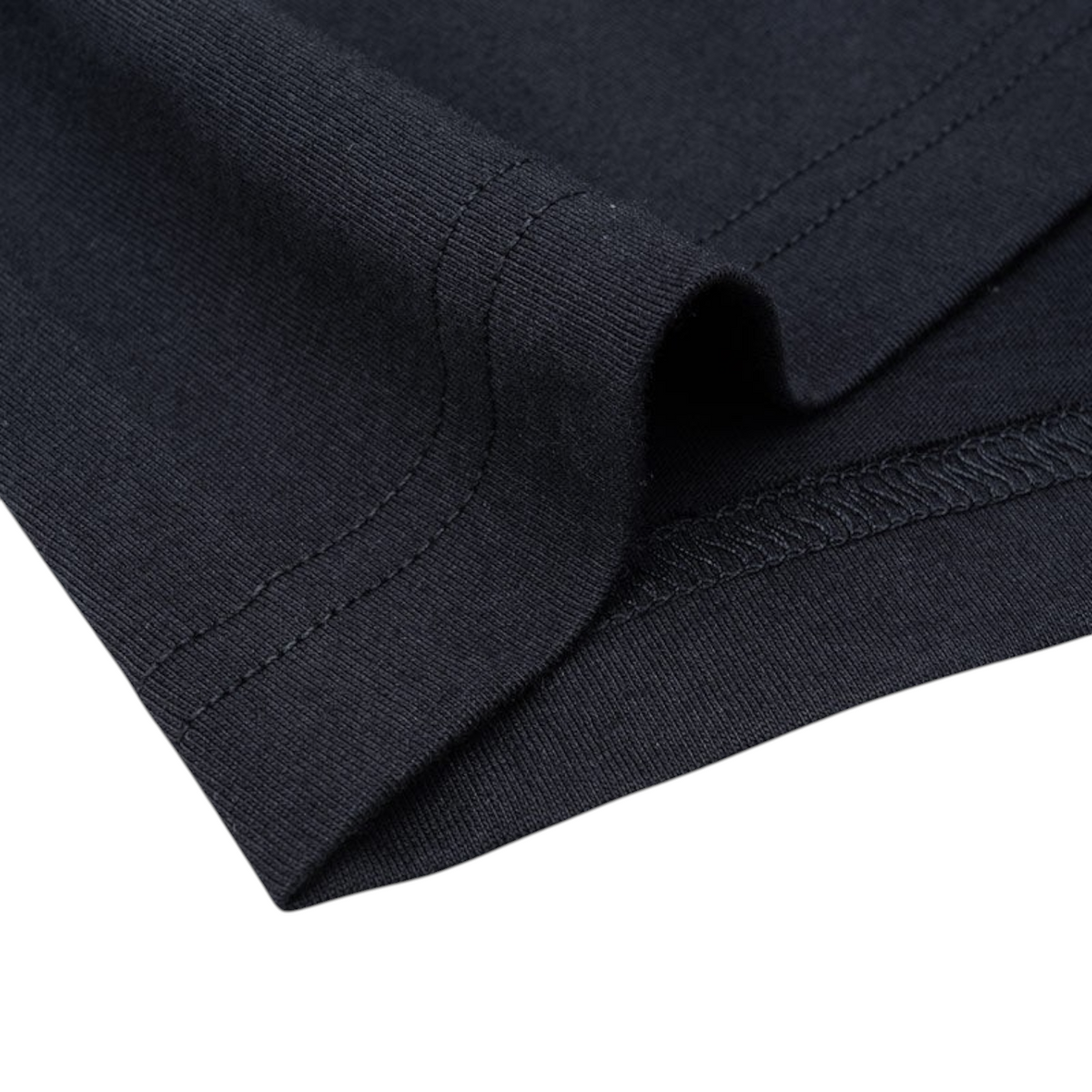 Close-up of the black cotton fabric and hem stitching on an ANTA Doll short sleeve t-shirt from FRG