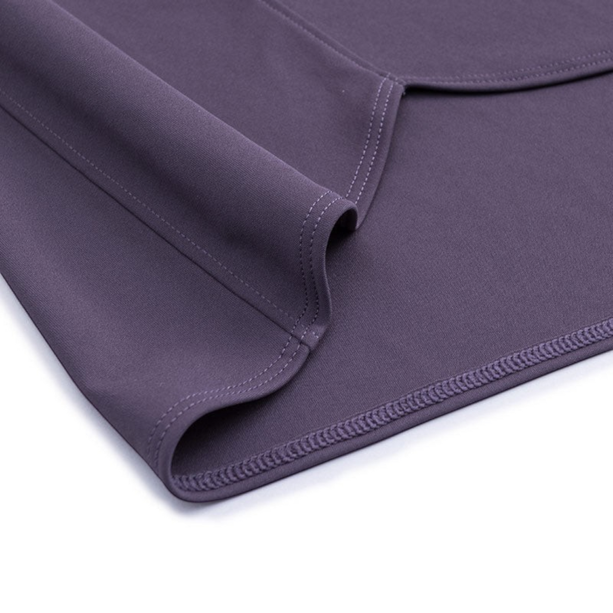 Close-up of the purple fabric hem on an FRG ANTA sweat-resistant running T-shirt with reinforced stitching.