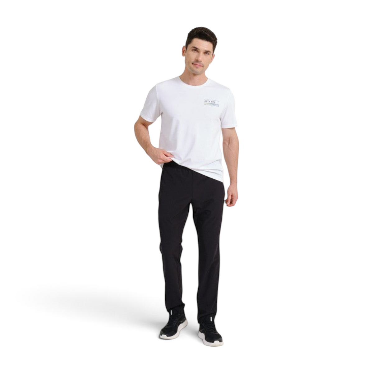 FRG model wearing black ANTA woven track pants with an elastic waistband and a white t-shirt for athletic training.