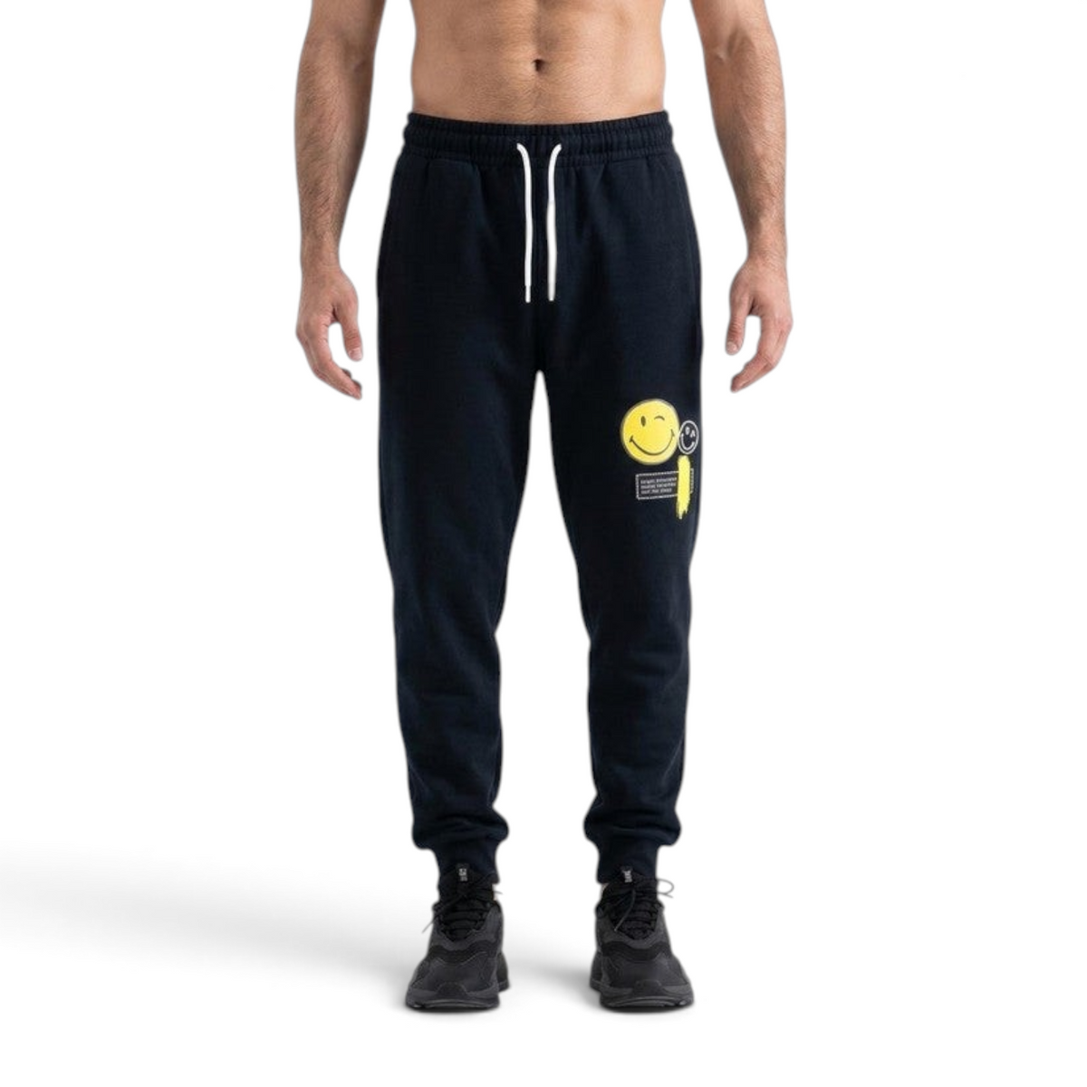 FRG ANTA black knit track pants with a yellow smiley face graphic, featuring a drawstring waist and cuffed ankles.