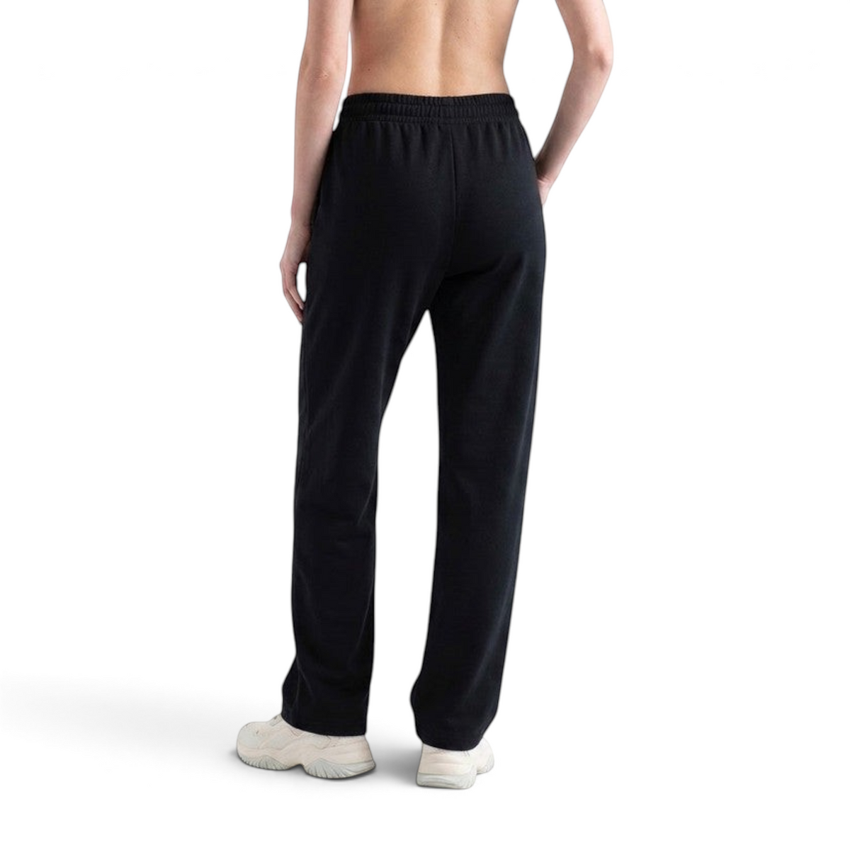 FRG ANTA knit track pants in basic black with a tapered fit, shown from the back on a model.
