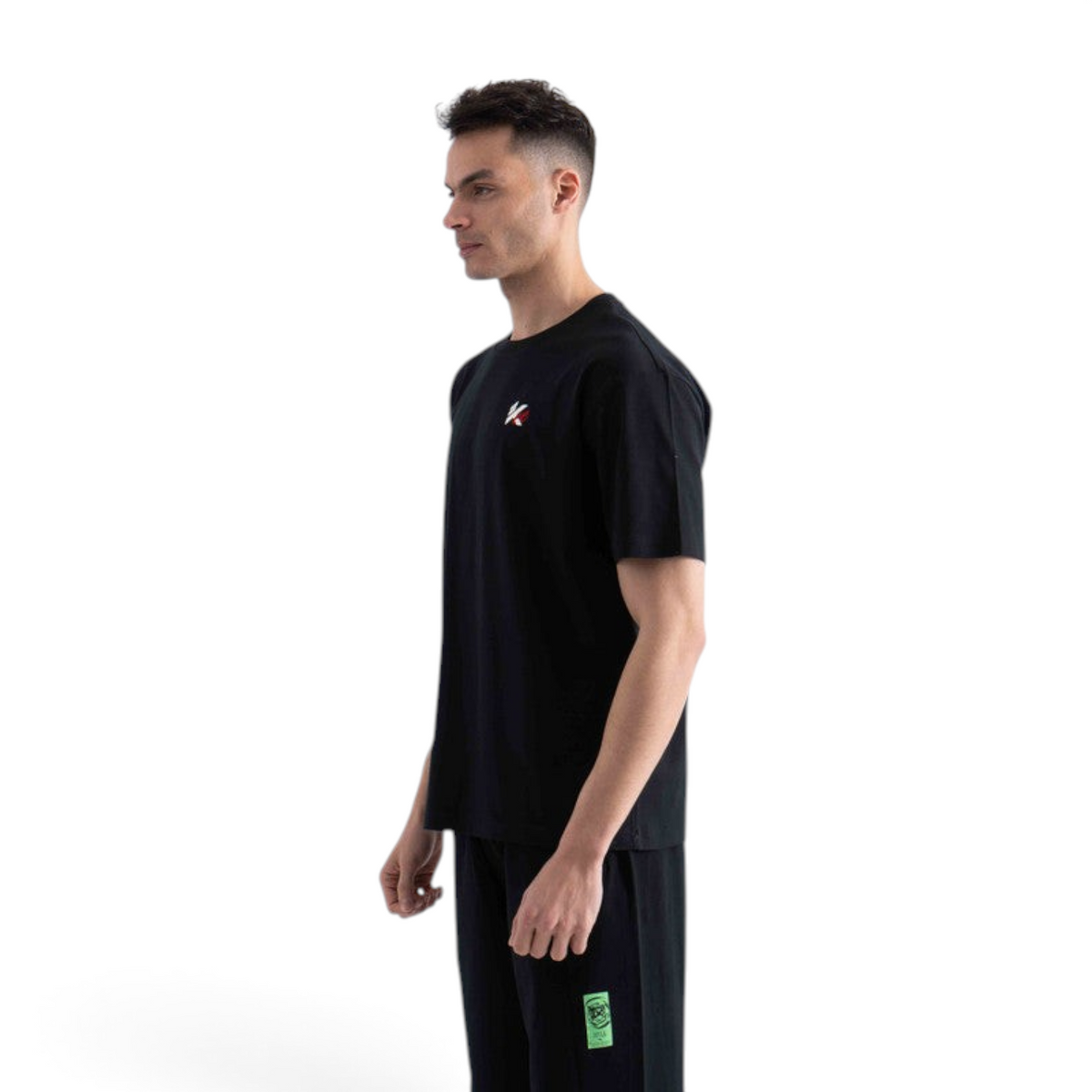 FRG black short sleeve t-shirt with small logo detail worn by a man in profile view